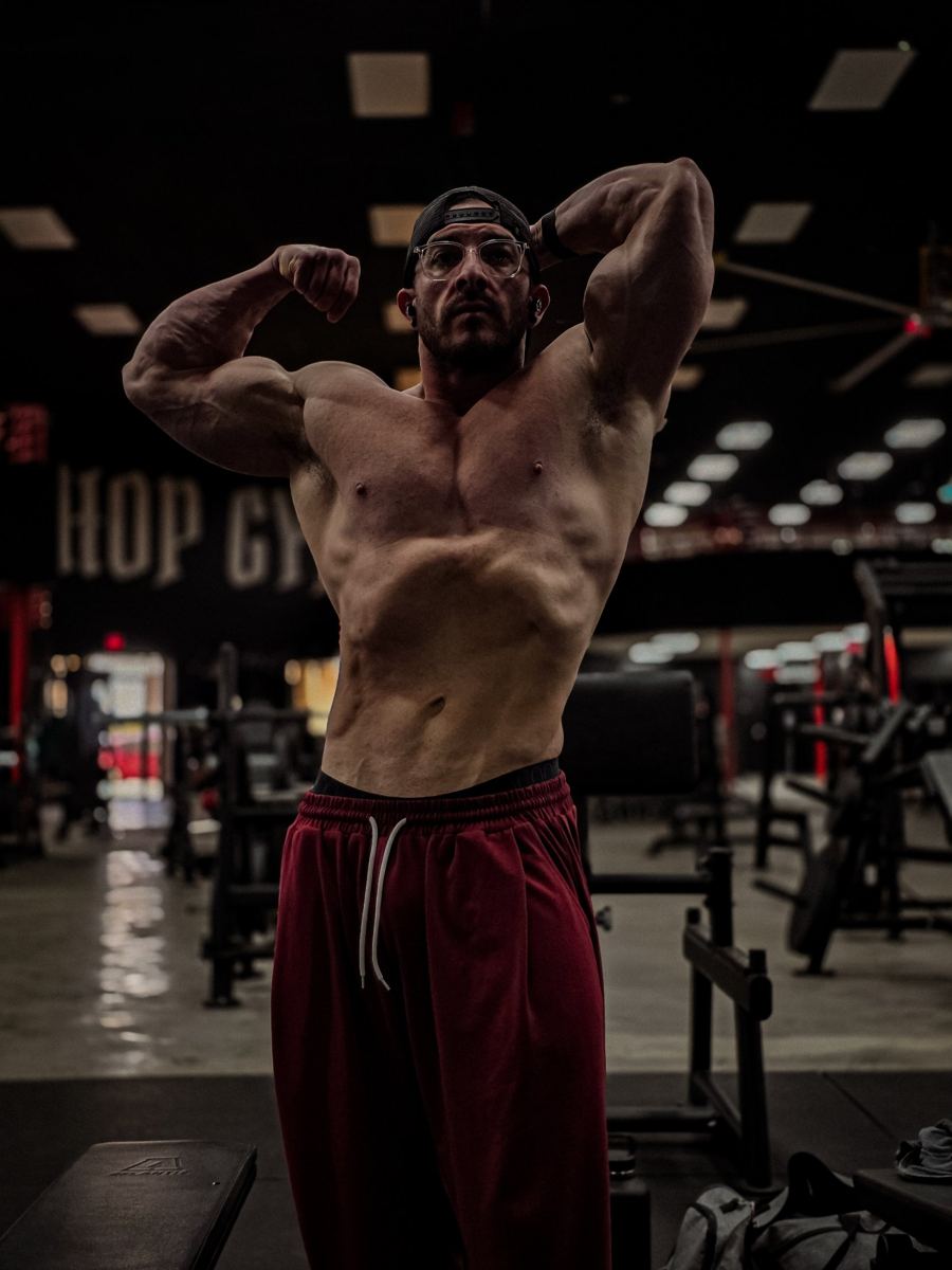 Adam Solis front double biceps in the gym